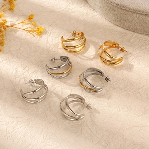 Three pairs of triple hoop stainless steel earrings in gold, silver, and two-tone finishes