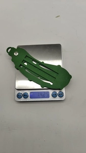 Detailed weight measurement of a green Christmas pickle ornament on a digital scale