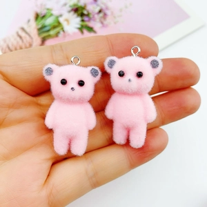Close-up of pink flocked mini bear charms with metal loops for DIY jewelry making