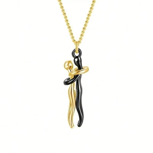Close-up of gold and black hugging figures pendant on a fine golden chain necklace