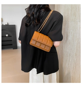 Detailed back view of a brown quilted leather crossbody bag with golden chain strap