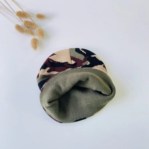Close-up of thick camouflage knit texture and warm inner layer on baby winter hat