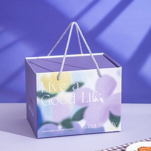 Elegant purple gift box with floral patterns and rope handles for ceramic coffee cup sets