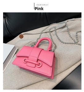 Close-up of pink mini beaded handbag with litchi grain leather on a gray coat