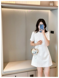 Fashionable silver heart-shaped acrylic crossbody bag with metal chain shown with model