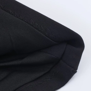 Detailed close-up showing the double-needle stitching on black knit fabric