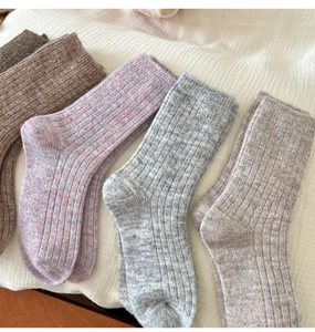 Detailed texture of thick wool ribbed knit socks in assorted gradient autumn colors