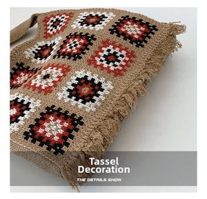Detailed close-up of bohemian knitted tote bag featuring geometric patterns and side tassels