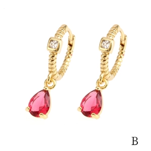 Detail of 18K gold hoop earring featuring red teardrop gemstone and square white zircon