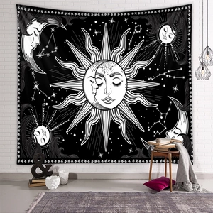 Detail of bohemian sun and moon tapestry on a white brick wall in a cozy room decor setting