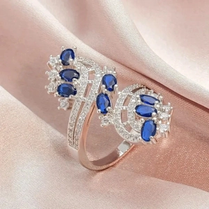 Luxurious silver ring featuring oval blue stones and white zircon wing design