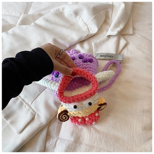 Detailed close-up of handmade crochet bag with cartoon duck design and floral pearl accents