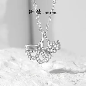 Macro shot of S925 silver ginkgo leaf pendant set with sparkling white cubic zirconia