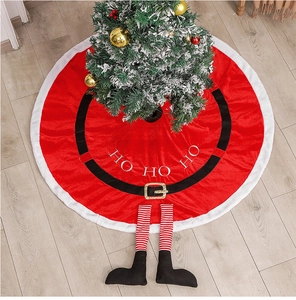 Detail of red Santa Claus tree skirt with plush trim, gold buckle, and elf boots decoration