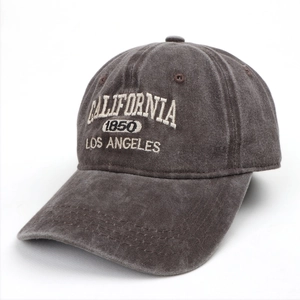 Detail of vintage washed denim baseball cap with California embroidery and stitched brim