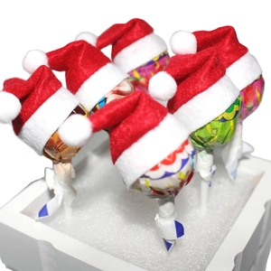 Mini red felt Christmas hats for lollipops and cutlery sets for festive table decor