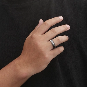 Close-up of vintage silver stainless steel ring with diamond weave pattern on finger