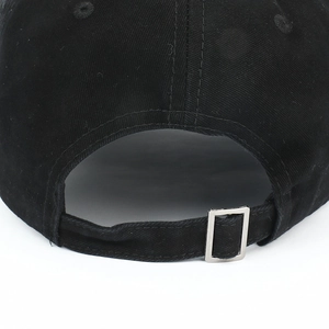 Detail of black cotton baseball cap with adjustable strap and silver metal buckle