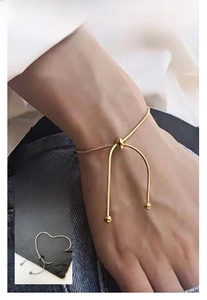 Detail of adjustable 18k gold plated snake chain bracelet with sliding bead closure