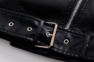 Detail of silver belt buckle and metallic zipper on a black faux leather biker jacket