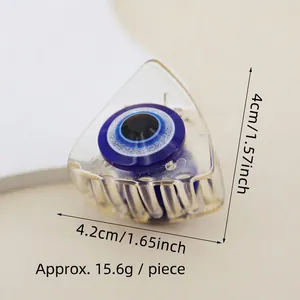 Detail view of small evil eye acrylic hair claw clip with 4.2cm by 4cm dimensions