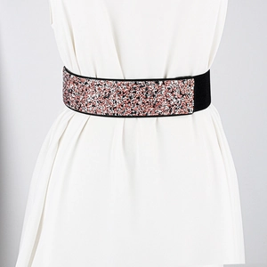 Detail of wide elastic belt featuring multi-color sparkling sequins on white dress