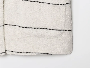 Primo piano del tessuto tweed bianco con strisce nere e trama di alta qualità