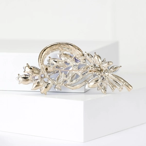 Detail view of the silver wheat brooch back featuring a secure pin clasp and rhinestones