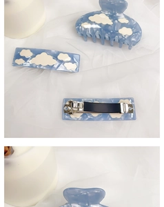 Detail of blue acetate hair claw and clips set with white cloud pattern on mesh