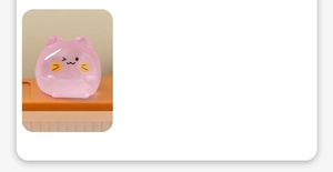Close-up of a luminous pink translucent cat figurine for micro landscape decor