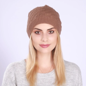 Detail view of the brown knitted beanie showing hollow diamond pattern and ribbed texture