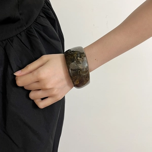 Chic irregular translucent amber resin bangle with marble texture for a trendy look