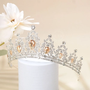 Macro detail of luxury crown featuring champagne teardrop crystals and silver rhinestones