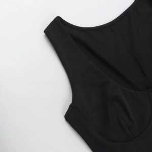 Detailed view of U-neckline stitching on a black slim-fit ruched mini dress