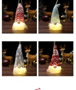 Macro detail of four glowing Christmas gnomes with knitted hats and warm LED lights
