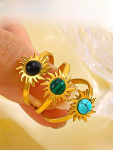 Detail view of sunflower rings with obsidian, malachite, and turquoise stone inlays
