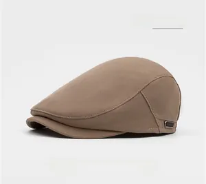 Detail of coffee brown flat cap featuring a textured honeycomb weave and metal buckle