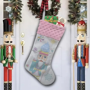 Detail of white Christmas stocking with Nutcracker soldier pattern and pink plush trim