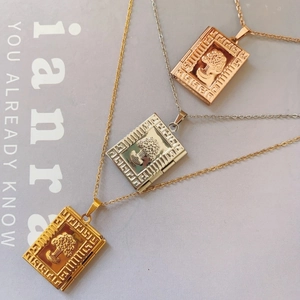 Detail of tree of life locket necklaces in gold, silver and rose gold finishes