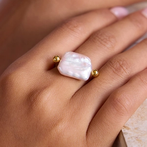 Minimalist stainless steel ring featuring a large rectangular baroque pearl and gold beads