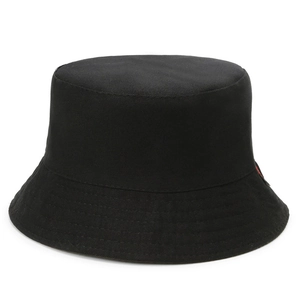 Close-up of black cotton bucket hat featuring a distinct red and black woven side label