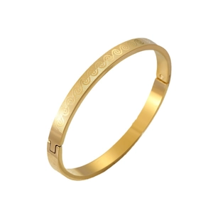 Polished gold stainless steel bangle featuring etched wave patterns and a secure hinge clasp