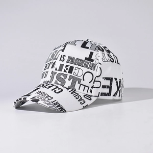 Detail view of cotton baseball cap featuring unique black fashion graffiti print on white fabric