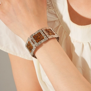 Detail of vintage silver wide bracelet with amber-colored textured geometric accents