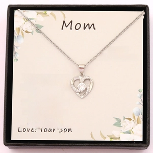 Detailed view of silver heart pendant with sparkling crystals in Mother's Day gift box