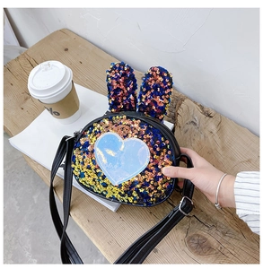 Detailed view of kids sequin crossbody bag with rabbit ears and colorful heart accent