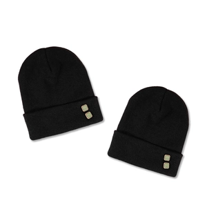 Fashionable black knitted beanies with decorative green buttons for winter warmth
