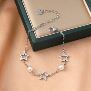 Star and pearl stainless steel bracelet featuring silver pentagram charms on a green box