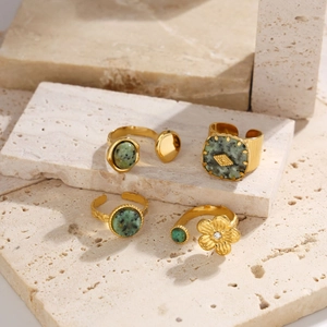 Set of four gold stainless steel rings featuring green dalmatian jasper stone inlays