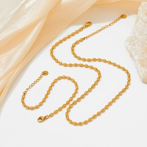 British style gold stainless steel bean chain bracelet and necklace set on silk fabric